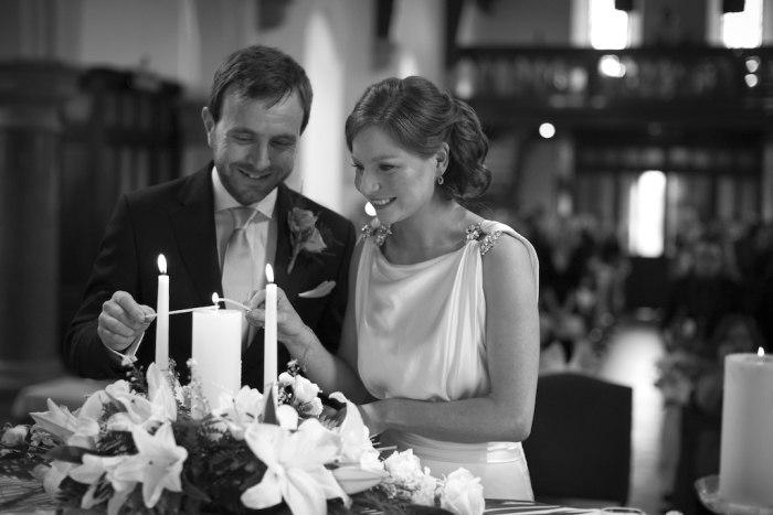 bride and groom lighting candles